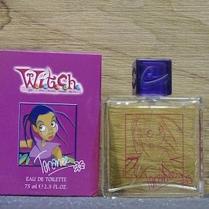 May include: A perfume bottle and box set featuring the Witch cartoon character Taranee. The box is purple with the Witch logo and a cartoon image of Taranee. The perfume bottle is clear with a purple cap and a Taranee graphic.