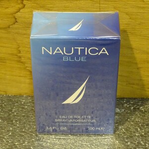 May include: A blue box of Nautica Blue eau de toilette spray. The box features the brand name and logo in white, with the text "EAU DE TOILETTE SPRAY VAPORISATEUR" and "3.4 FL. OZ. 100 ml e" printed on the front.