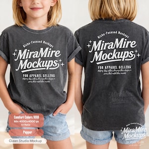 May include: A charcoal gray short-sleeve t-shirt featuring white text that reads Niche-Focused Mockups MiraMire Mockups For Apparel Sellers. The design includes small star accents. The shirt is shown from both the front and back views.