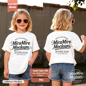 May include: A white t-shirt mockup featuring the text "MiraMire Mockups" in black, worn by a child. The front and back of the shirt are visible, paired with denim shorts. The image includes text indicating the shirt is Comfort Colors 9018, with a 1:1 ratio.