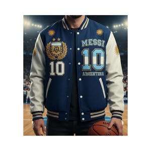 May include: A navy blue and white varsity jacket with the name "MESSI" and the number "10" on the front. The jacket also features the text "ARGENTINA" and the AFA logo. The sleeves are white, and the jacket has a snap-button closure.