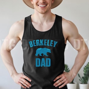 May include: Black tank top with the text "BERKELEY DAD" in blue, featuring a blue bear graphic. The tank top is sleeveless and made of a soft material.