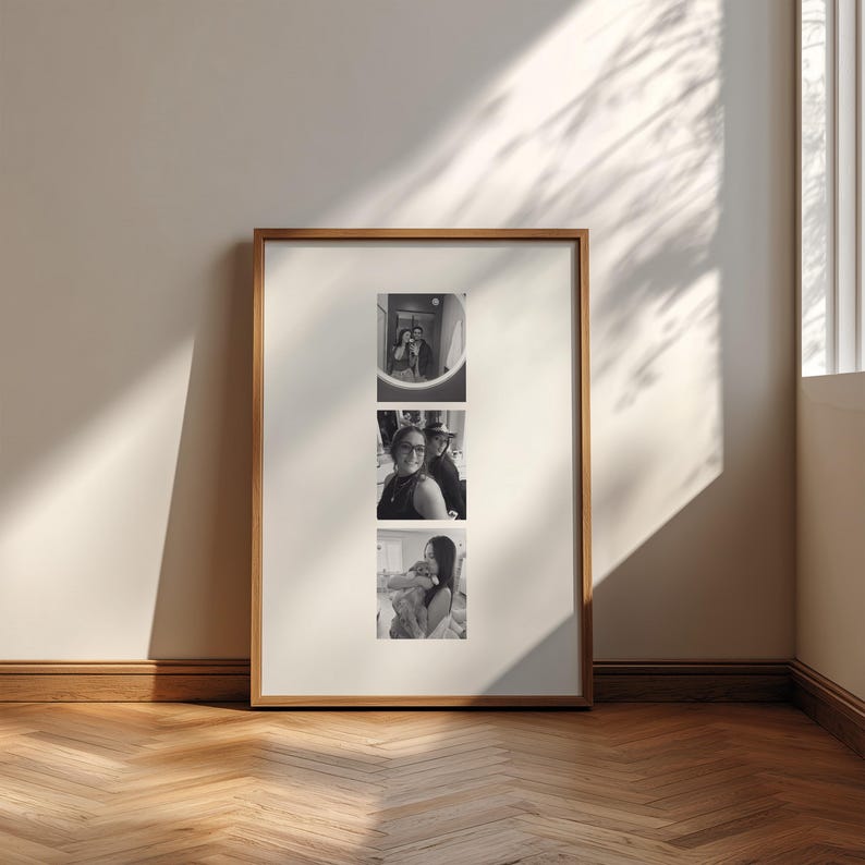 May include: A vertical rectangular wooden frame containing a white mat with three stacked black and white photographs. The top photo shows two people, the middle photo shows two people, and the bottom photo shows a person holding a small dog.