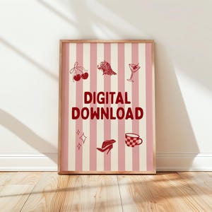 May include: A framed print with a pink and white striped background. The print features red illustrations of cherries, a lion, a cocktail, stars, a high heel, and a checkered teacup. The words "DIGITAL DOWNLOAD" are in bold red letters.