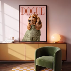 Puede incluir: Un cuadro enmarcado con la palabra "DOGUE" y un perro con un suéter verde. El cuadro está encima de un mueble amarillo, con una silla verde y una alfombra a cuadros. Una lámpara redonda está sobre el mueble.