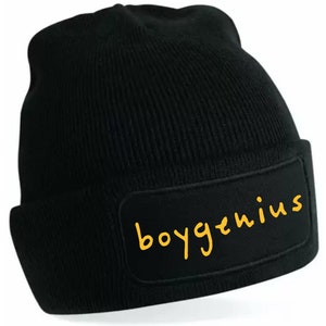 May include: Black beanie with a yellow patch that says "boygenius" on it.