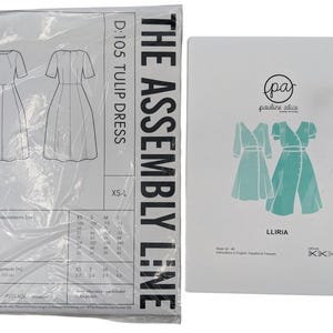 May include: Two sewing pattern packages. One package is labeled "THE ASSEMBLY LINE D:105 TULIP DRESS" with a diagram of a dress. The other package is labeled "pauline alice LLIRIA" with a diagram of a dress.