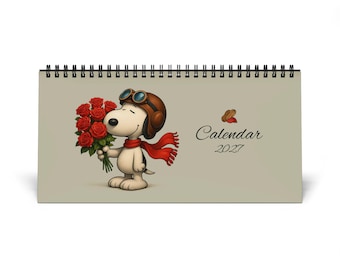 May include: A spiral-bound 2027 calendar featuring a cartoon dog wearing a brown aviator cap with goggles and a red scarf, holding a bouquet of red roses. The text reads Calendar 2027, accompanied by a small graphic of two peanuts above the word Calendar.