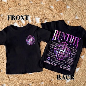 May include: Two black t-shirts with the word "FRONT" and "BACK" printed on them. The front shirt has a purple and pink graphic. The back shirt has the word "HUNTRIX" and other text in a similar color scheme.