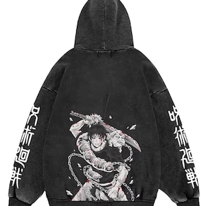 May include: A black hooded sweatshirt with a worn effect. The back displays a manga character with a sword, chains, and blood details. White Japanese text is printed on the sleeves.