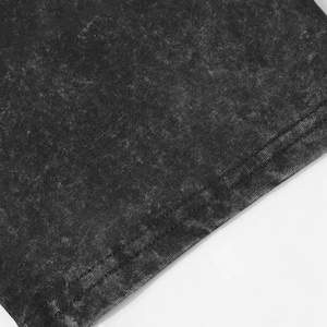 May include: Close-up of a section of a dark gray, acid-wash style fabric. The fabric has a textured appearance with lighter areas, and a visible seam runs along the edge. The background is white.