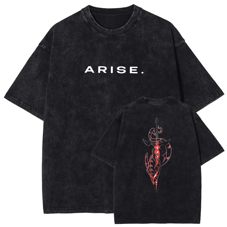 May include: Black acid wash t-shirt with the word "ARISE." in white block letters. The back of the shirt features a red and black graphic design of a sword and abstract shapes. The shirt has short sleeves and a crew neck.