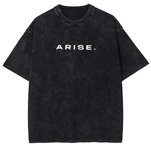 May include: Black, short-sleeved t-shirt with the word "ARISE." printed in white. The shirt has a faded, textured appearance. The t-shirt is a casual wear item.