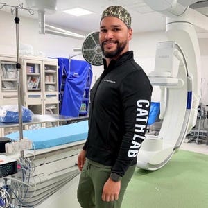Peut inclure: Une veste zippée noire à manches longues avec le texte CATHLAB imprimé en blanc sur la manche, associée à un pantalon de jogging vert olive, une calotte chirurgicale à motif camouflage et des baskets blanches et noires à semelles épaisses.