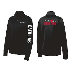 May include: Black zippered jacket with a red heart and EKG graphic on the back that says "STEMI TEAM". The left sleeve has white text that says "CATH LAB".