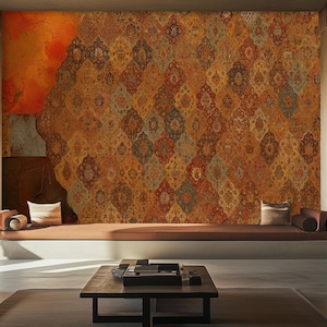 May include: An interior design scene featuring a large wall with a patterned, textured mural in shades of orange, brown, and gold. The room includes a built-in bench, a coffee table, and two dark blue sofas, creating a warm and inviting atmosphere.