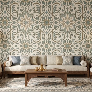 May include: A living room interior with a beige sofa, wooden furniture, and decorative cushions. The wall is decorated with patterned wallpaper in beige, green, and gold tones. Two gold lanterns hang on the wall, and a wooden coffee table is in front of the sofa.
