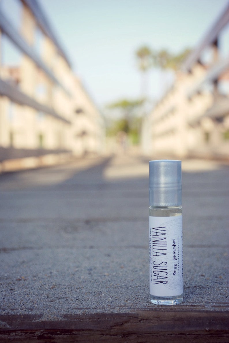 vanilla sugar perfume oil in glass roller ball bottle sitting on a pier