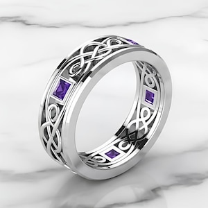 May include: A silver ring with a Celtic knot design and square purple gemstones. The ring has a polished finish and a detailed pattern. The gemstones are evenly spaced around the band.
