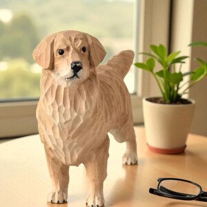 May include: A wooden sculpture of a Golden Retriever dog, standing with its tail up. The dog is carved from light-colored wood, with detailed texture. The sculpture is a decorative item, likely for home decor.