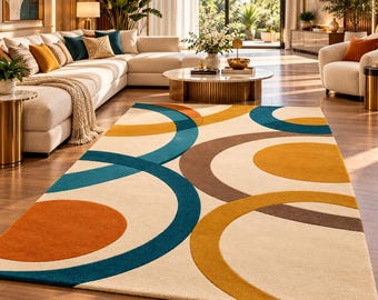 May include: A rectangular area rug featuring a cream-colored background with a large-scale geometric pattern of overlapping circles and arcs in shades of teal, mustard yellow, burnt orange, and dark brown, creating a bold visual design.