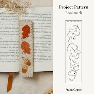 May include: A felt bookmark with a fall theme. The bookmark features three orange leaves and two acorns with stitched details. The words "Project Pattern Bookmark" are printed on the right side.