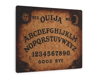 May include: A square Ouija board with a distressed, aged appearance. The board features the alphabet, numbers, and the words "YES," "NO," and "GOOD BYE." Decorative sun and moon symbols are present. The board has a brown and black color scheme.
