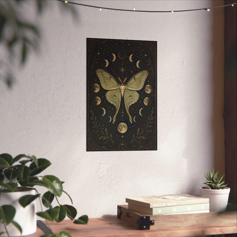 Luna Moth Moon Phases poster featuring a vintage celestial moth surrounded by lunar phases on a black background. Witchy wall art with botanical and mystical details, perfect for cottage witch decor, pagan altar spaces, gothic home decoration, moon lovers, Wiccan interiors, celestial aesthetic rooms, and nature-inspired spiritual gifts.