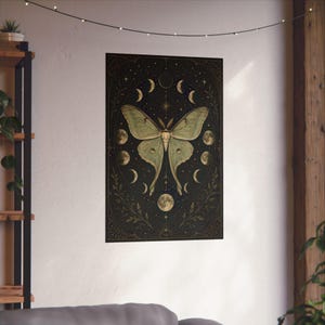 Luna Moth Moon Phases poster featuring a vintage celestial moth surrounded by lunar phases on a black background. Witchy wall art with botanical and mystical details, perfect for cottage witch decor, pagan altar spaces, gothic home decoration, moon lovers, Wiccan interiors, celestial aesthetic rooms, and nature-inspired spiritual gifts.