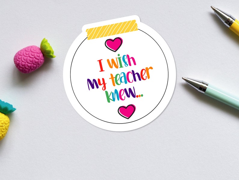 May include: A white sticker with a yellow and white striped border. The sticker has a rainbow colored text that says "I wish my teacher knew..." with a pink heart on either side of the text.