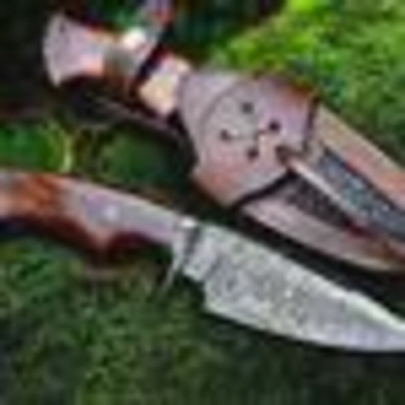 May include: A handcrafted hunting knife with a patterned blade and a wooden handle, presented with a leather sheath. The knife is approximately 9 inches long overall.