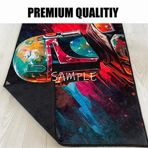 May include: A rectangular rug with a colorful graphic design featuring a helmet and the word "SAMPLE". The rug has a black backing and the text "PREMIUM QUALITIY" at the top.