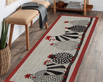May include: A rectangular rug with a whimsical chicken design. The rug features a light beige background with a red border. The chickens are black and white, with red accents. The rug is placed on a hardwood floor.