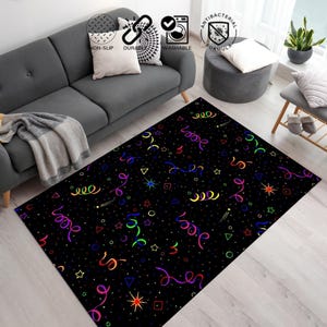 May include: Black rectangular rug with a vibrant confetti design. The rug showcases stars, circles, and triangles, alongside colorful, curly ribbons. The rug is positioned in a living room, adding a playful touch to the space.