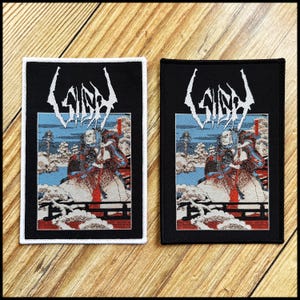 May include: Two rectangular patches with a detailed illustration. The top of each patch has the word "GIDE" in white, stylized lettering. Below, a figure in a kimono stands on a bridge, with a snowy landscape in the background. One patch has a white border, the other a black border.