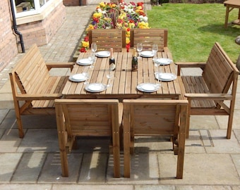 May include: A wooden outdoor dining set with a rectangular table and seating for eight. The set includes a table, two benches, and four chairs. The table is set with plates, glasses, and bottles, ready for a meal. The set is made of light brown wood.