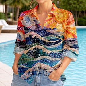 May include: Button-down shirt with a vibrant, artistic design featuring a sun, waves, and clouds in shades of orange, blue, and green. The long-sleeved shirt is worn with blue jeans. The overall theme is a nature-inspired, artistic design.