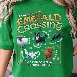 May include: Green t-shirt with the text "EMERALD CROSSING" and illustrations of animals, including a sheep, dog, and bull. The shirt also has the text "An Irish Adventure Through Psalm 23".