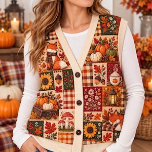 May include: A sleeveless button-down cardigan vest featuring a patchwork design of autumn-themed illustrations including foxes, pumpkins, sunflowers, mushrooms, acorns, and lanterns, finished with a cream-colored ribbed V-neck and trim.