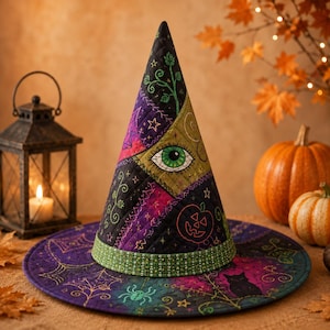 May include: A quilted witch hat featuring a patchwork design in shades of purple, green, and black. The fabric displays embroidered motifs including a green eye, a jack-o'-lantern, a spider, a cat, and stars. A green patterned band encircles the base.