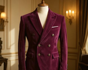 May include: A burgundy velvet double-breasted blazer displayed on a mannequin. The blazer features a notched lapel, four front buttons, and two side pockets. The brand name "ARISTOMODE" is visible at the top.