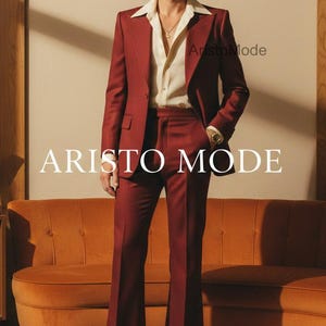 May include: A burgundy suit with a white shirt and sunglasses. The suit includes a blazer and flared pants. The text "ARISTO MODE" is displayed on the image. A vintage-style orange sofa is in the background.