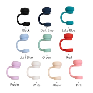 May include: A collection of colorful silicone straw toppers in various shades, including black, dark blue, lake blue, light blue, green, red, purple, white, khaki, and pink. Each topper has a rounded top and a curved, open-ended design.