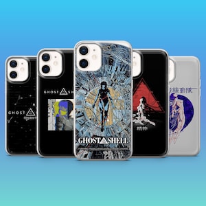 May include: A selection of phone cases with graphic designs. The cases showcase artwork with text including "GHOST IN THE SHELL" and Japanese characters. The designs incorporate a variety of colours, including black, white, blue, and red.