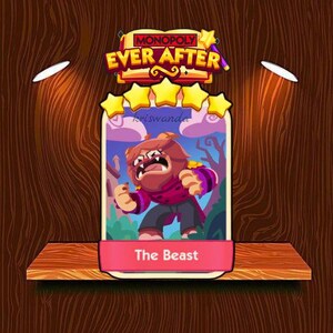 May include: A Monopoly Ever After game card featuring The Beast character. The card has a pink banner with the text "The Beast" and a cartoon illustration of the character. The card is set against a wooden background.