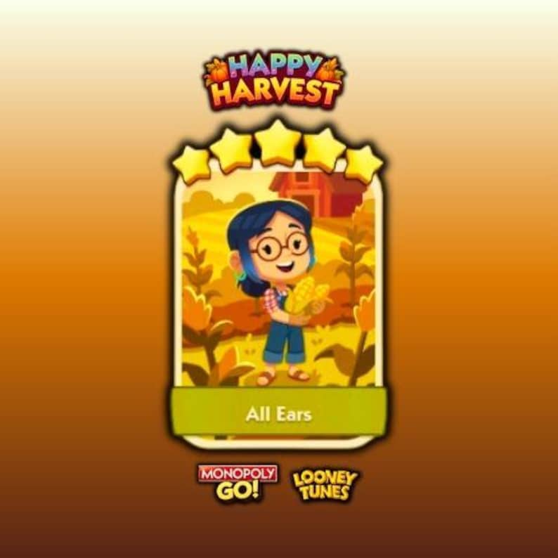 Peut inclure: Une carte de jeu num&eacute;rique intitul&eacute;e Happy Harvest repr&eacute;sentant un personnage de dessin anim&eacute; aux cheveux fonc&eacute;s et lunettes portant une salopette, tenant du ma&iuml;s jaune dans un champ. La carte affiche cinq &eacute;toiles jaunes, le texte All Ears et les logos Monopoly Go et Looney Tunes.