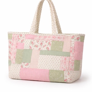 May include: A patchwork tote bag with a rectangular shape and two handles. The bag features a variety of fabric patterns, including pink floral, gingham, and dotted designs, along with solid green patches. The handles are cream-colored with small dots.