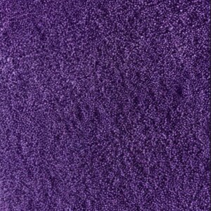 May include: A close-up of a deep purple carpet. The carpet has a dense, textured surface, with many small, tightly packed fibres. The colour is a rich, saturated shade of purple, creating a soft, inviting appearance.