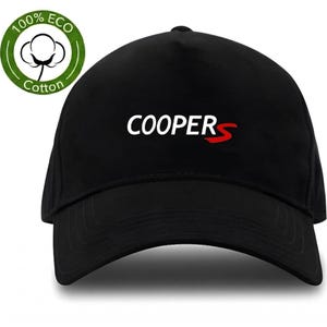 May include: Black baseball cap with the word "COOPER S" in white and red lettering. The cap has a curved brim and a rounded crown. A green and white circular logo with the words "100% ECO Cotton" is on the left side.