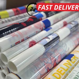 May include: A stack of rolled-up posters with various designs and text, including "MIAMI" and "SUNSET ELEMENTARY". The posters are wrapped in clear plastic. The image also includes a "24h FAST DELIVERY" graphic.
